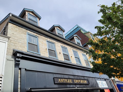 A building with a sign that says "Antique Emporium" on it.