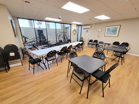 A conference room with a long table and chairs.
