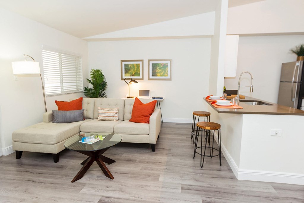 a living room with a couch and a kitchen