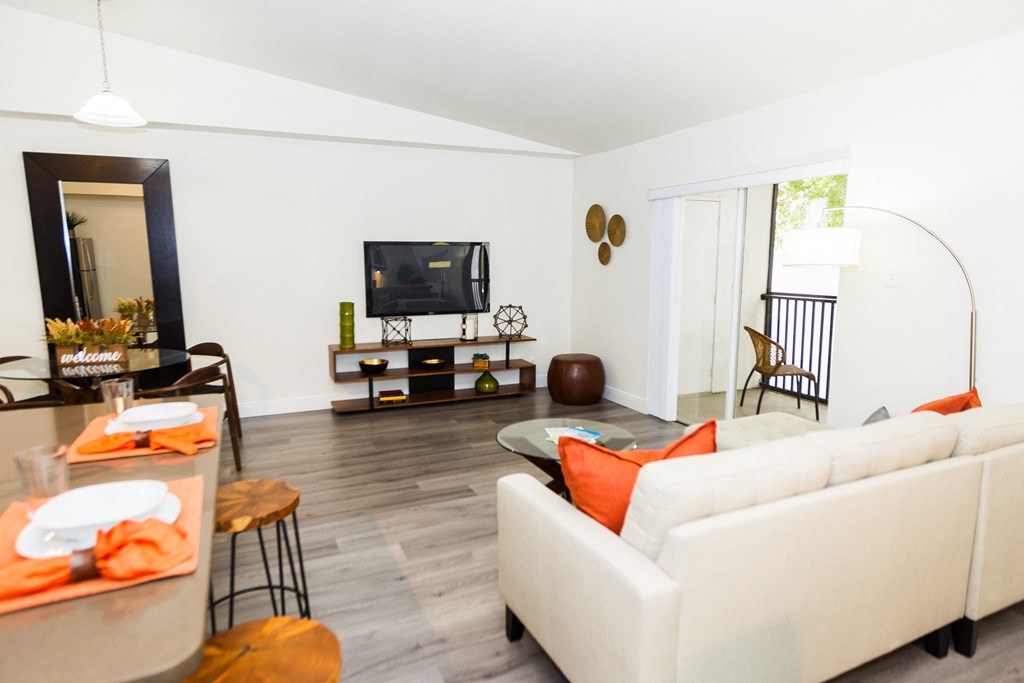 a living room with a white couch and a television