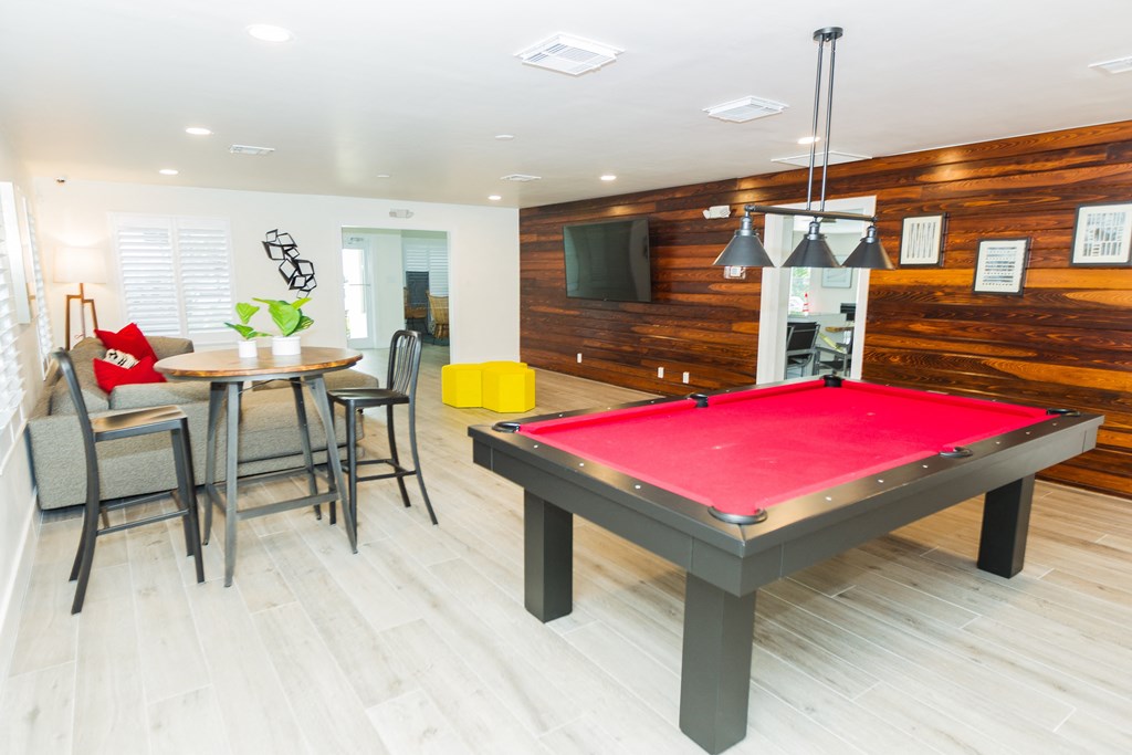 a billiards table in a living room with a red pool