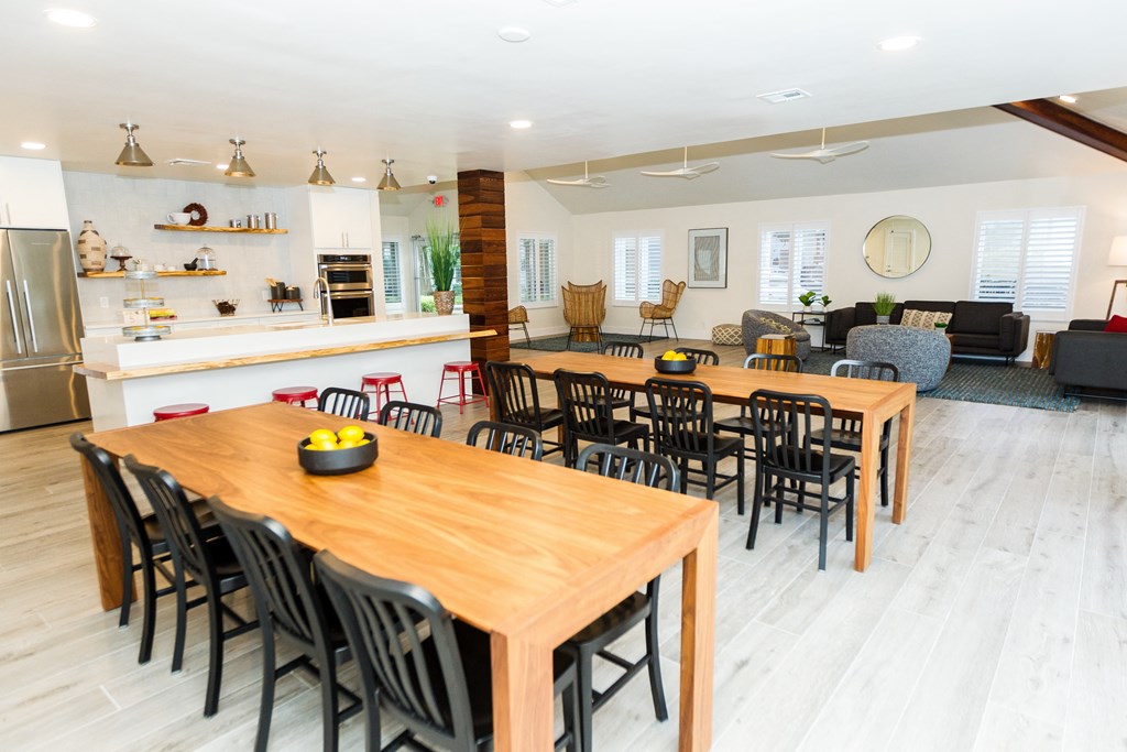 the dining room and living room of a house with wooden tables and chairs