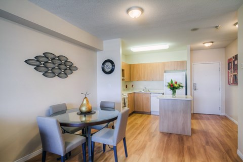 A dining room with a table and chairs.