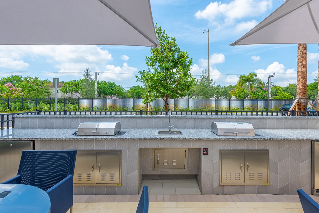 a restaurant with a counter with three microwaves and a table with chairs