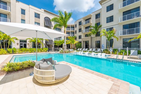 a swimming pool in front of an apartment building