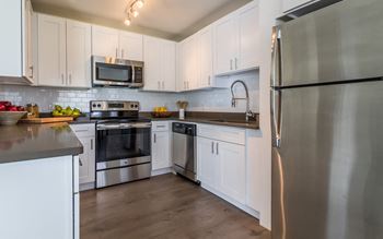 A spacious kitchen with stainless steel appliances at The Harbor.