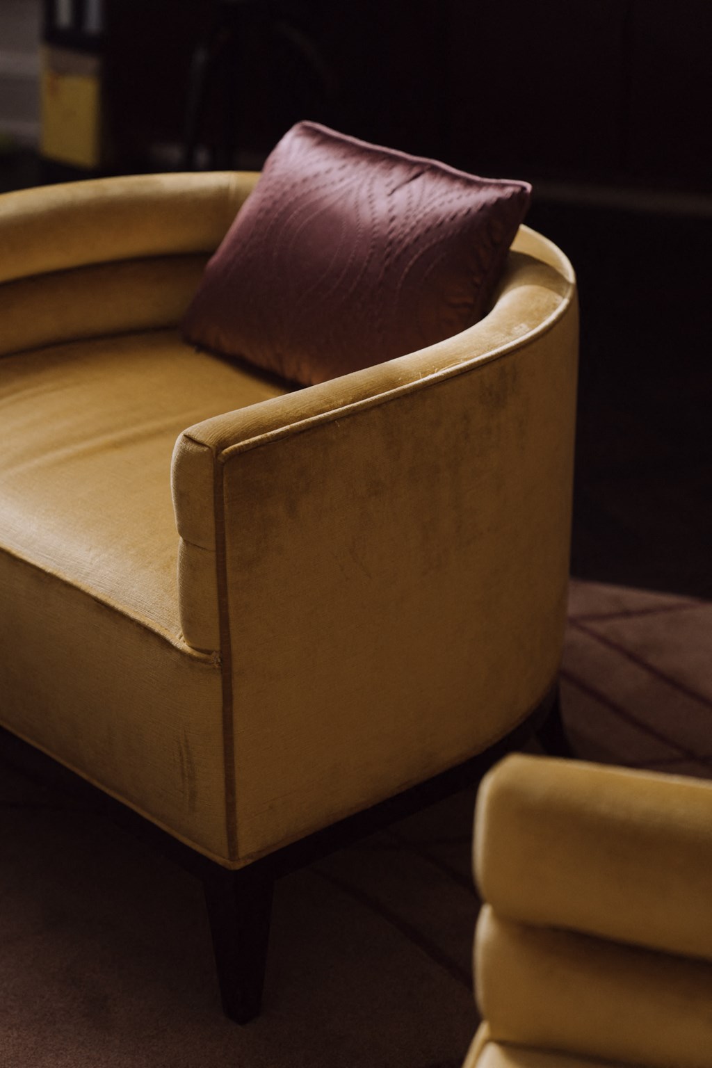 a leather chair with a brown pillow in a room