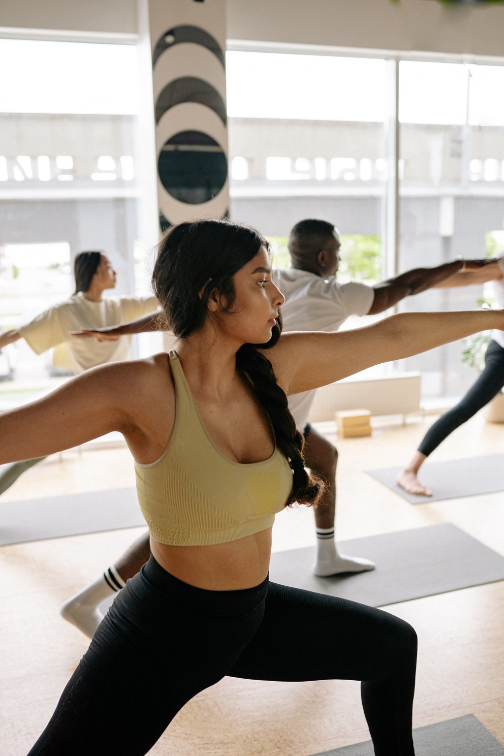 a group of people doing yoga in a gym