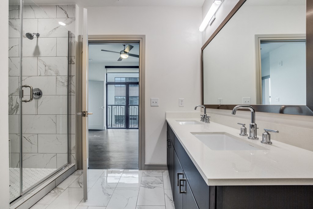 a bathroom with a large mirror and two sinks