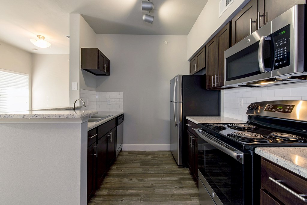 a kitchen with stainless steel appliances and black and white appliances