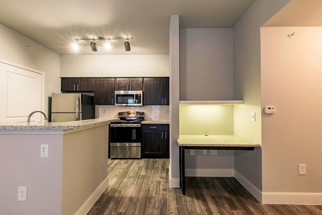 a view of a kitchen with a counter top and a refrigerator