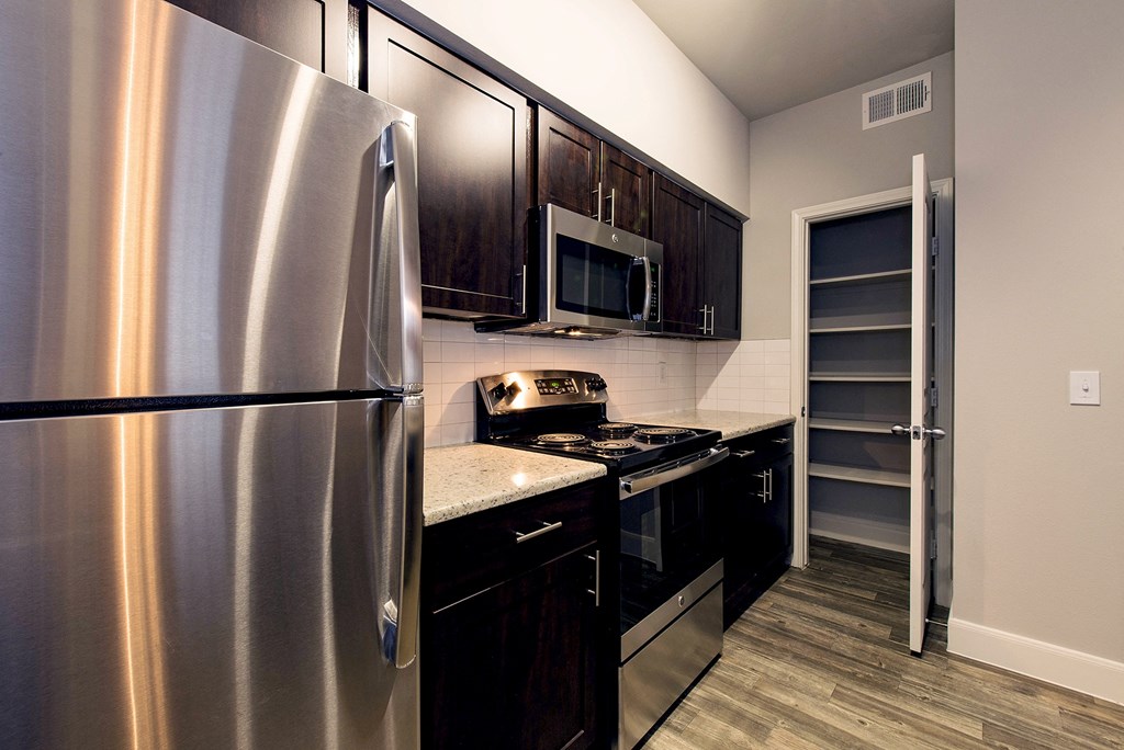a kitchen with stainless steel appliances and a stainless steel refrigerator