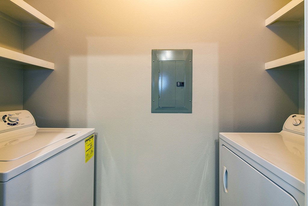 a washer and dryer in a laundry room with a door on the wall