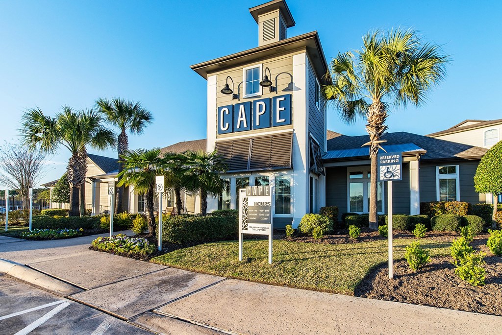 a building with a sign that says cape in front of palm trees