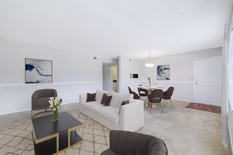 A living room with a white couch and a coffee table.