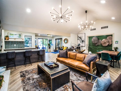 A modern living room with a brown leather couch and a black coffee table.