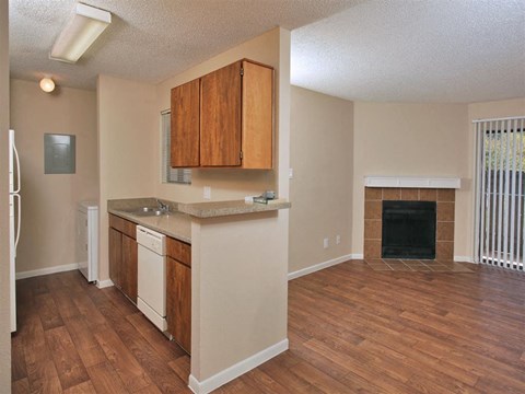 A kitchen with wooden cabinets and a black fireplace.