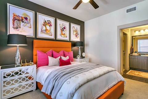 a bedroom with a bed and a ceiling fan