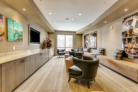 A modern living room with a brown leather chair and wooden floors.