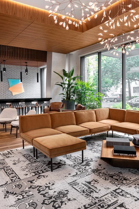 A living room with a large sectional sofa and a coffee table.