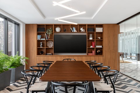 A modern dining room with a wooden table and chairs.