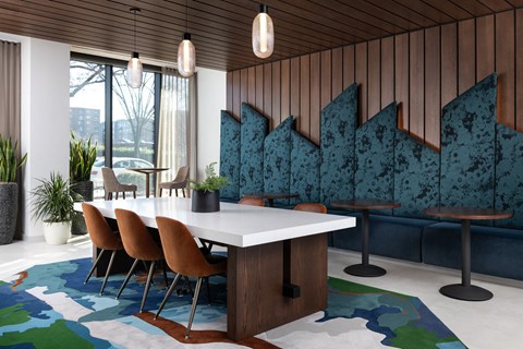 A dining room with a white table and chairs.