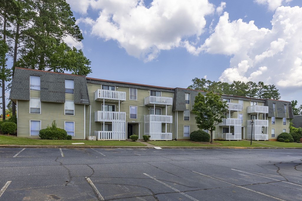Apartment building with a parking lot in front. at Peachtree Place Apartments, Columbia, SC
