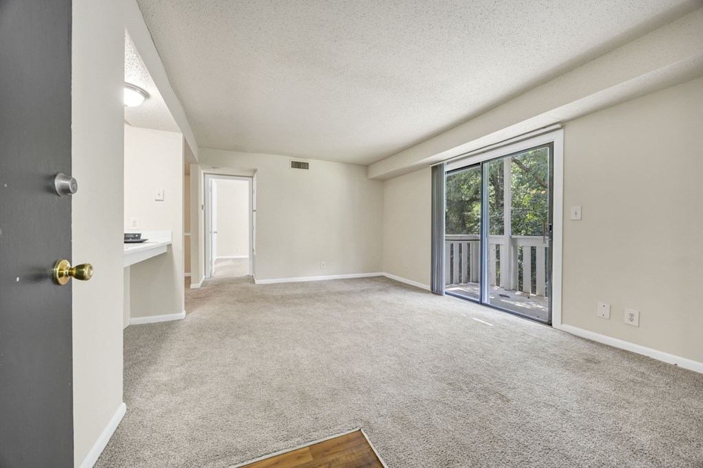 A room with a grey carpet and a wooden floor at Peachtree Place Apartments, Columbia 29210