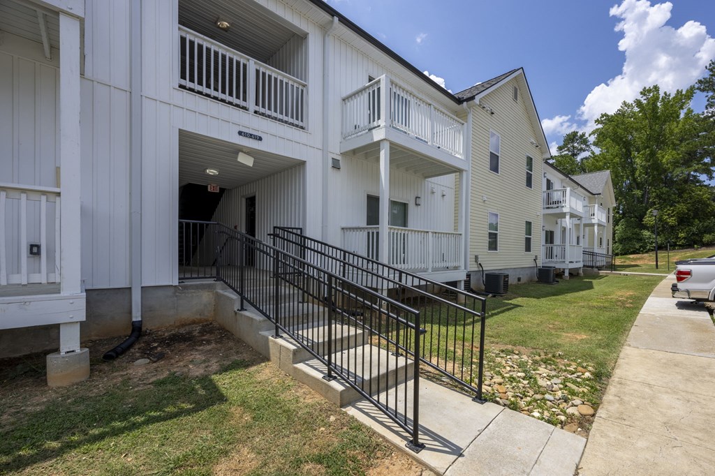 A white building with a black gate in front at Peachtree Place Apartments, Columbia, South Carolina