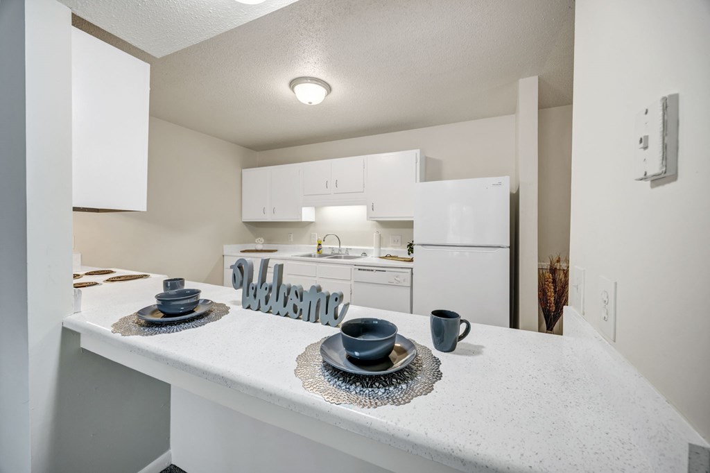 A kitchen with a white countertop and a white refrigerator at Peachtree Place Apartments, Columbia, SC