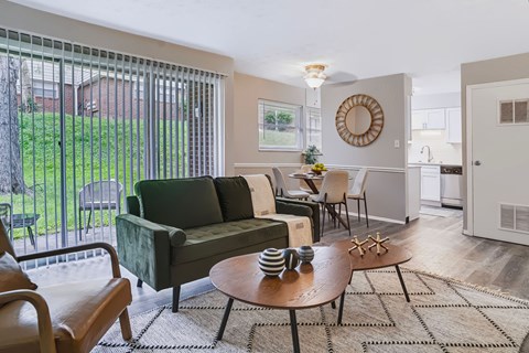 A living room with a green couch and a wooden coffee table.