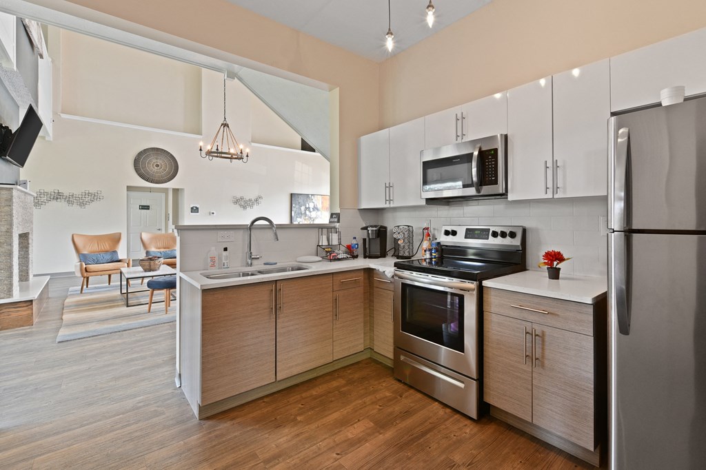 a modern kitchen with stainless steel appliances and wooden cabinets