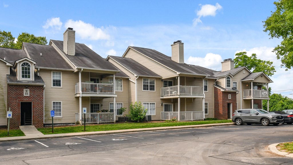 a large apartment building with cars parked in front of it