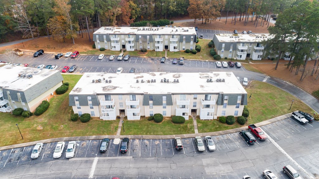 An aerial view of a parking lot with cars and two buildings. An aerial view of a parking lot with cars and two buildings.at Peachtree Place, Columbia, 29210
