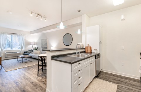 a kitchen with white cabinets and a sink and a counter top at Corso Apartments, Missoula, MT