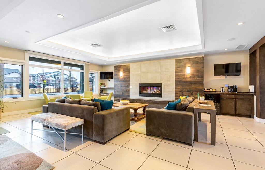 a living room with couches and chairs and a fireplace