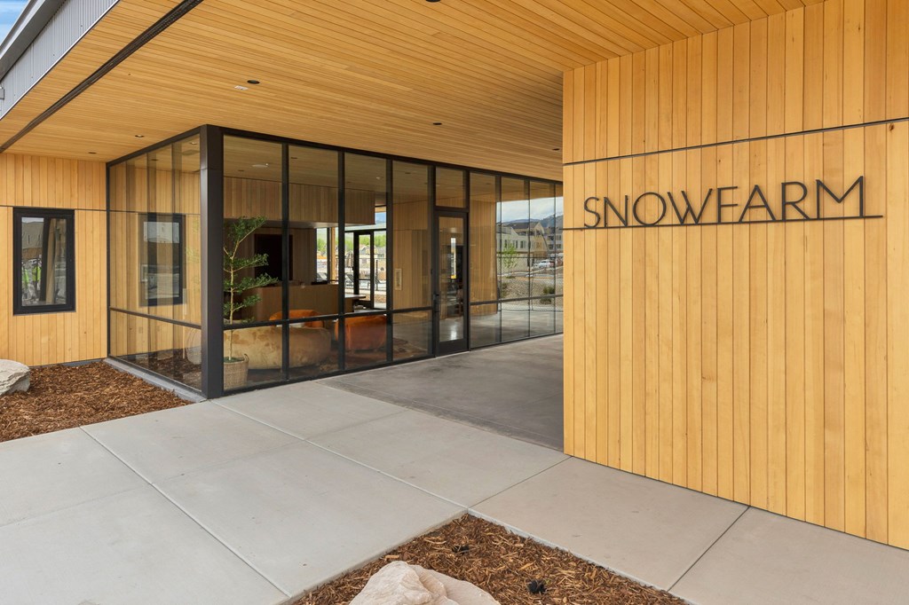 The entrance to a building with the name SNOWFARM on it.
