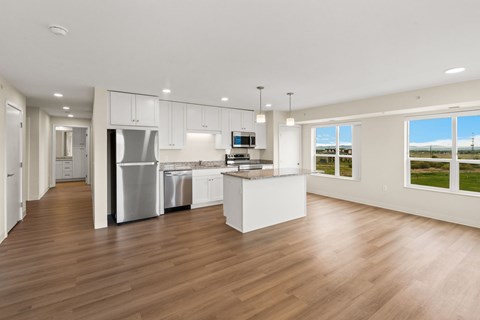 A modern kitchen with white cabinets and stainless steel appliances at The Beaumont Apartments, Bozeman, MT