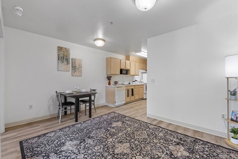 A kitchen with a table and chairs in the middle of the room.