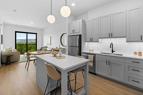 A modern kitchen with a dining table and chairs.