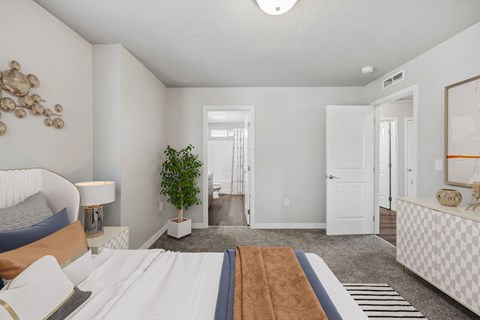a bedroom with a large bed and a door to a hallway