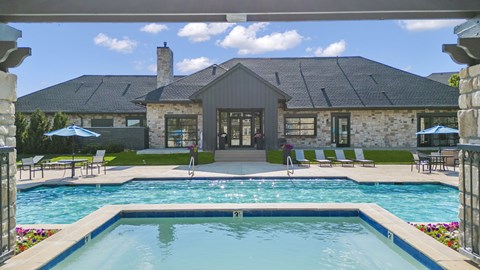 a swimming pool with a house in the background