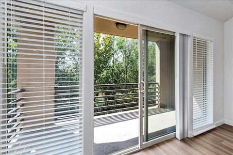 a living room with sliding glass doors and a balcony