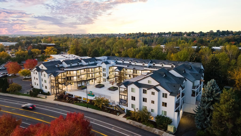 an aerial view of a large white building with a street in front of it