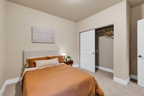 A bedroom with a bed and a painting on the wall at Brooklyn West Apartments, Missoula, MT