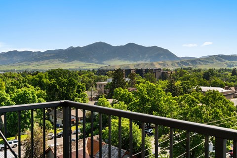 A mountain range is in the background of a green valley.