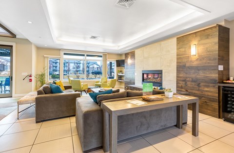 a living room with couches and chairs and a table at Corso Apartments, Missoula, MT