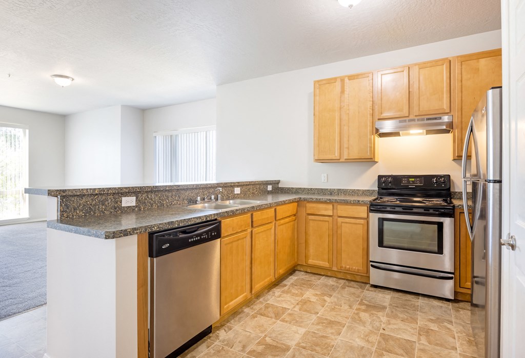 A kitchen with wooden cabinets and stainless steel appliances. at Ashlyn Place, Montana, 59801