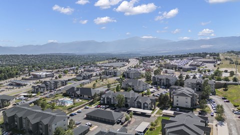 an aerial view of a suburb of a city with mountains in the background