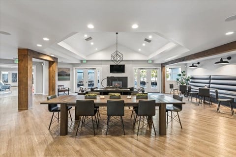 a large dining room with a table and chairs